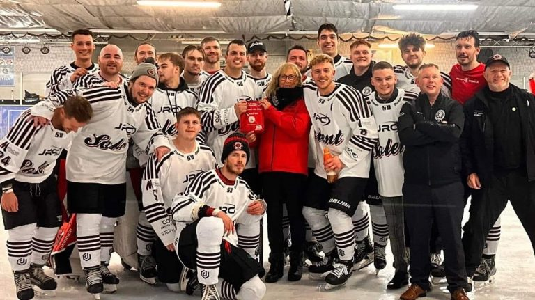 Two ice hockey players from the Solent Devils ice hockey team holding a Daniel Baird Bleed Control Kit donated by money raised by Adam's Angels.