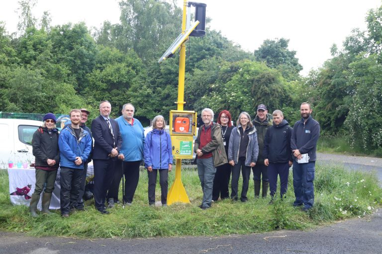 Representatives from St John Scotland and RSPB at RSPB Baron’s Haugh Nature Reserve with Turtle's wind and solar powered defib cabinet