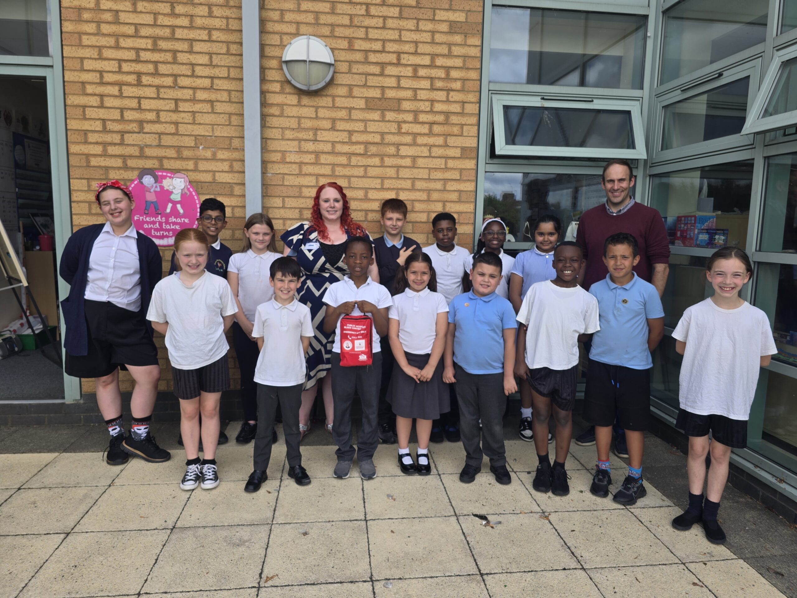 Fereday's First Response with children and staff at Wren’s Nest Primary School, Dudley with an ‘original’ The Daniel Baird Foundation bleed control kit